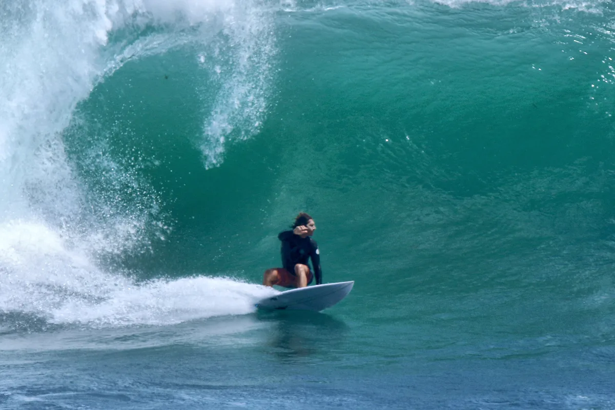 Surfer riding a wave at Uluwatu, Bali